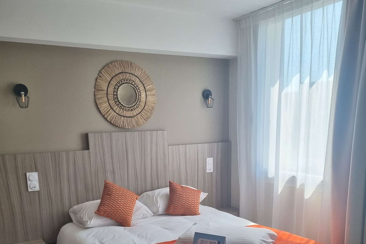 Biancheria da letto di alta qualità, una scrivania, tende oscuranti