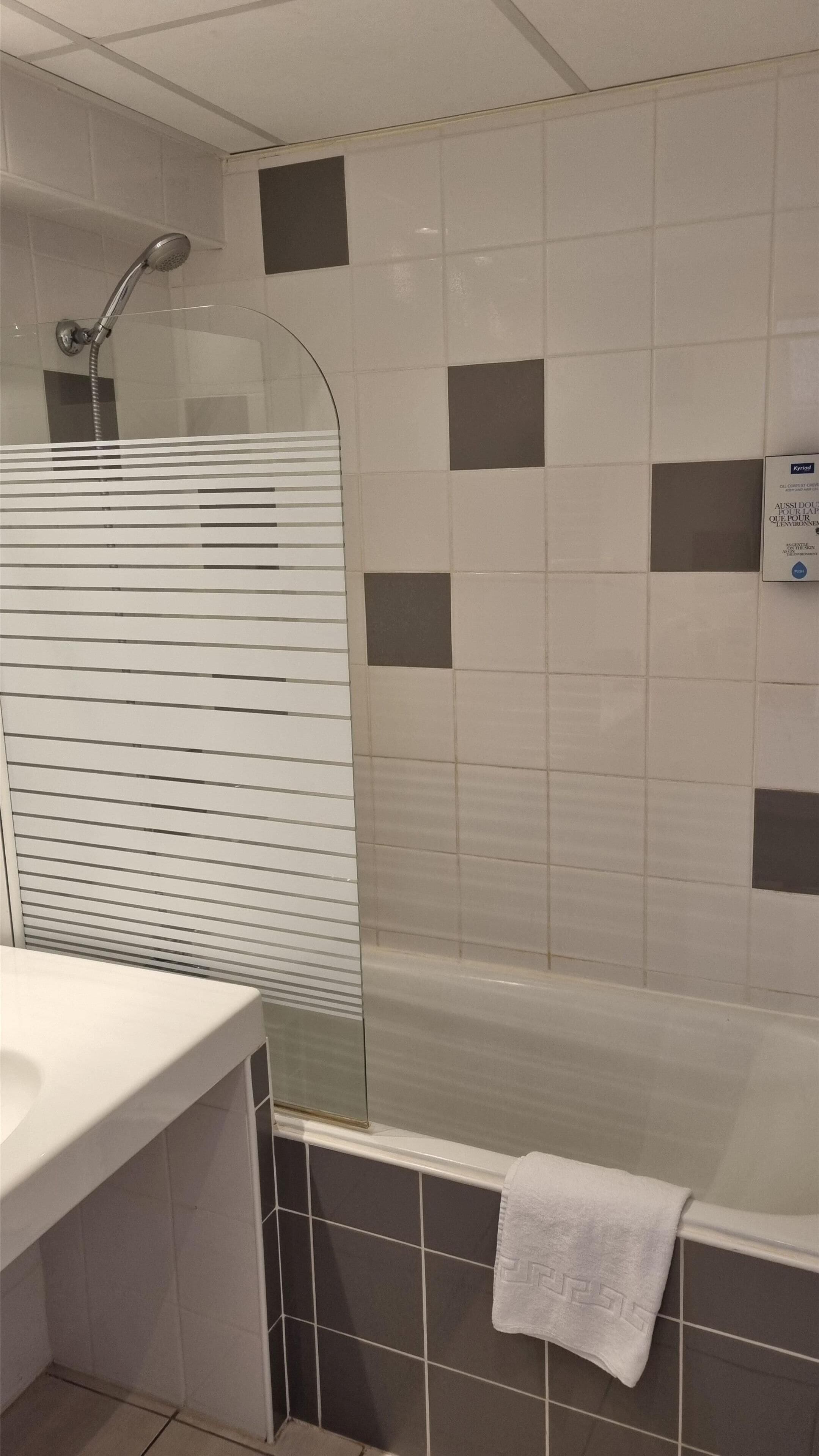 A bathroom with a bathtub, a shower, and a sink.