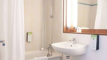 A bathroom with a bathtub, a sink, and a toilet.
