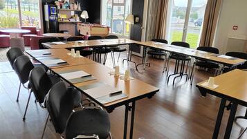 Ein Konferenzraum mit langen Tischen, Stühlen und einem Tischfußballspiel.