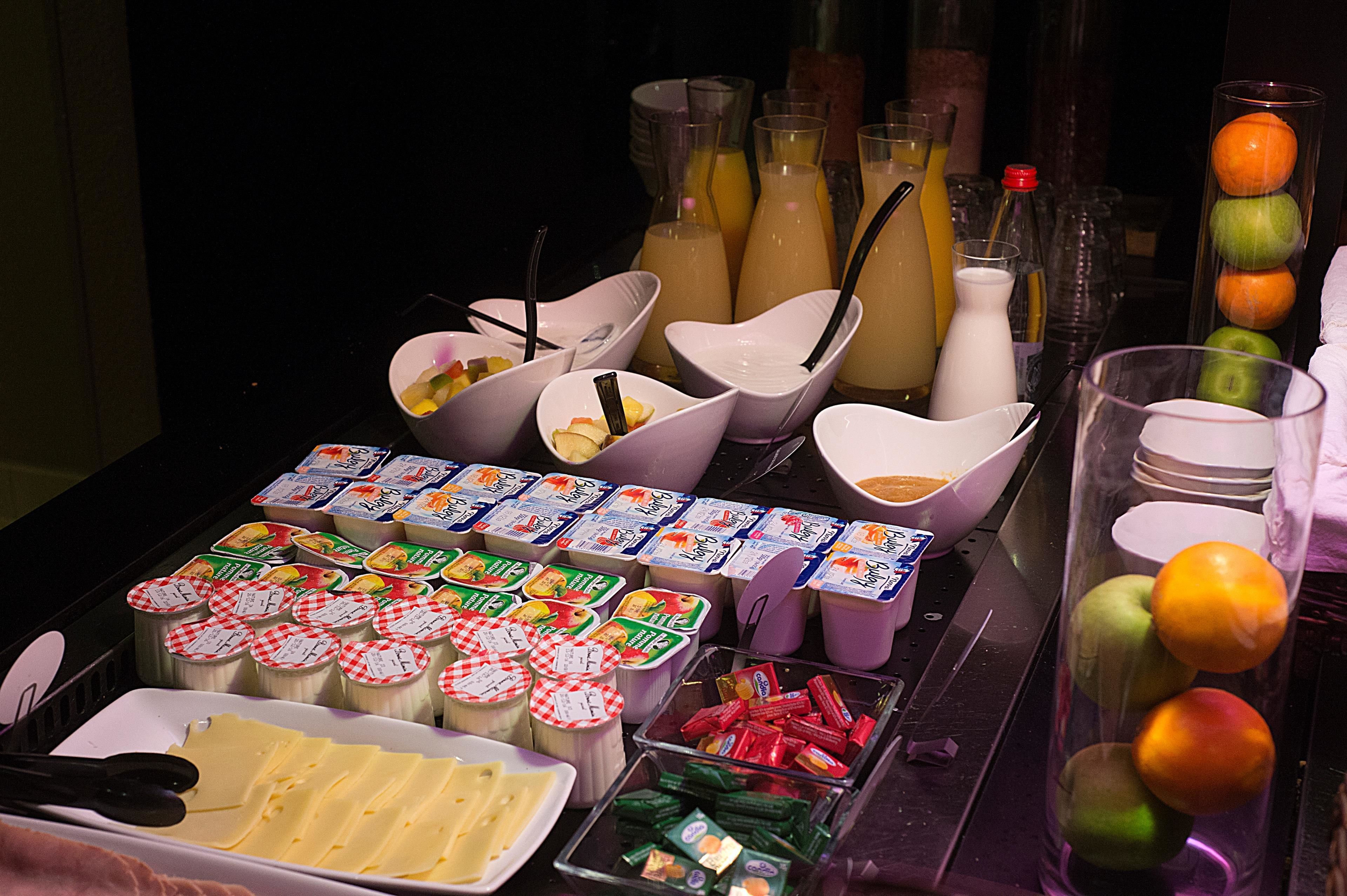 A breakfast buffet with various food items and beverages.