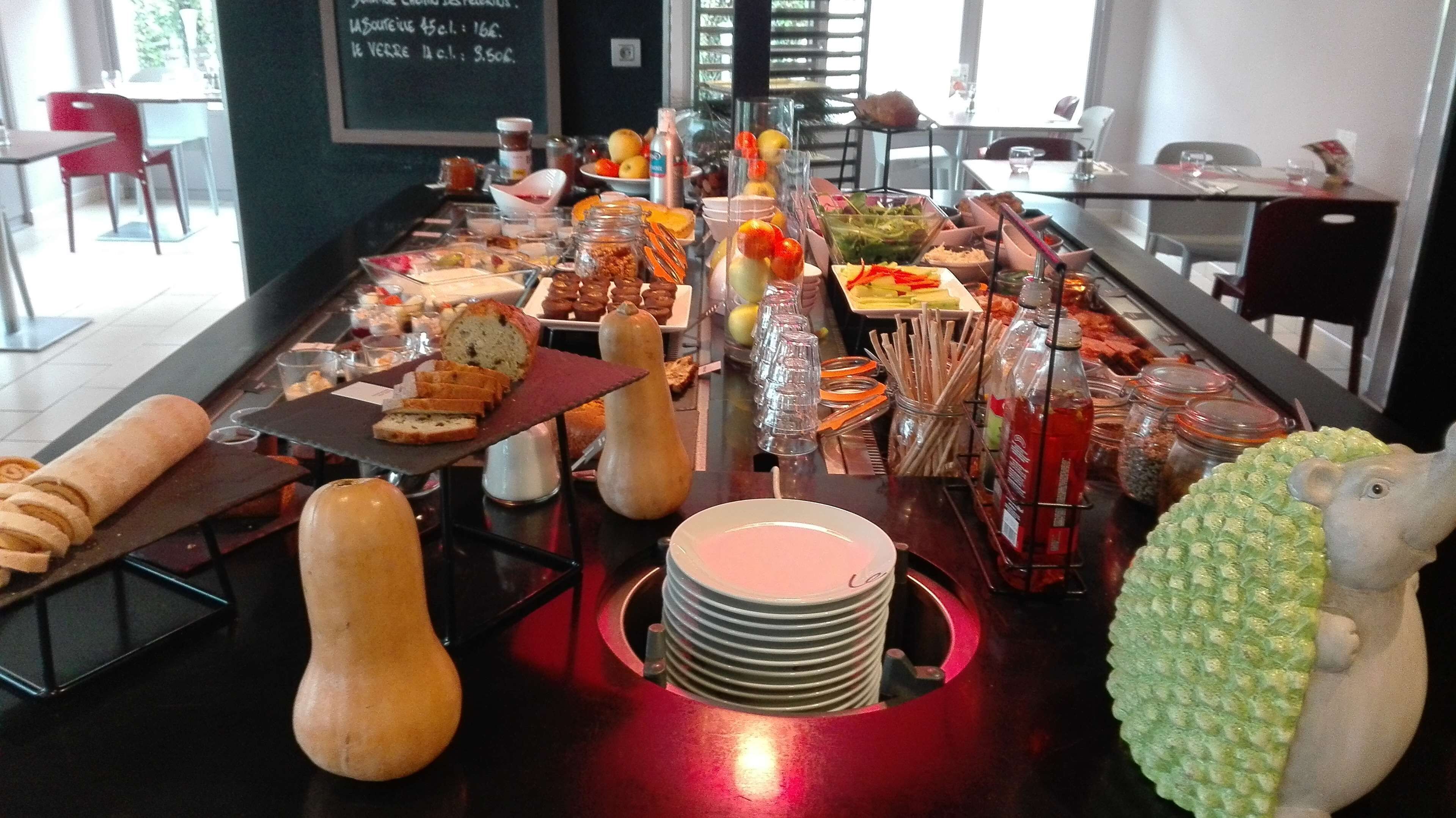 A buffet setup with various food items and utensils.