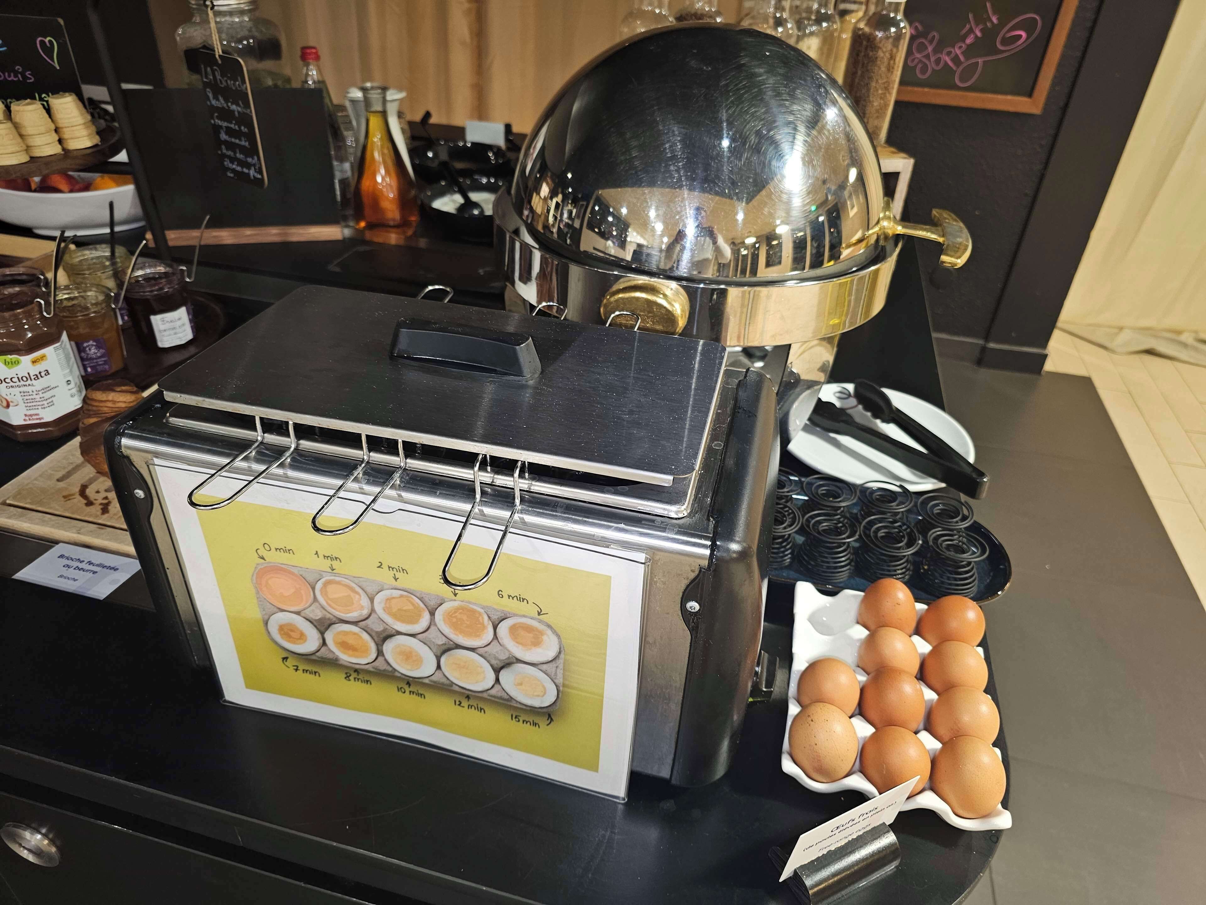 A breakfast station with a timer, eggs, and condiments.