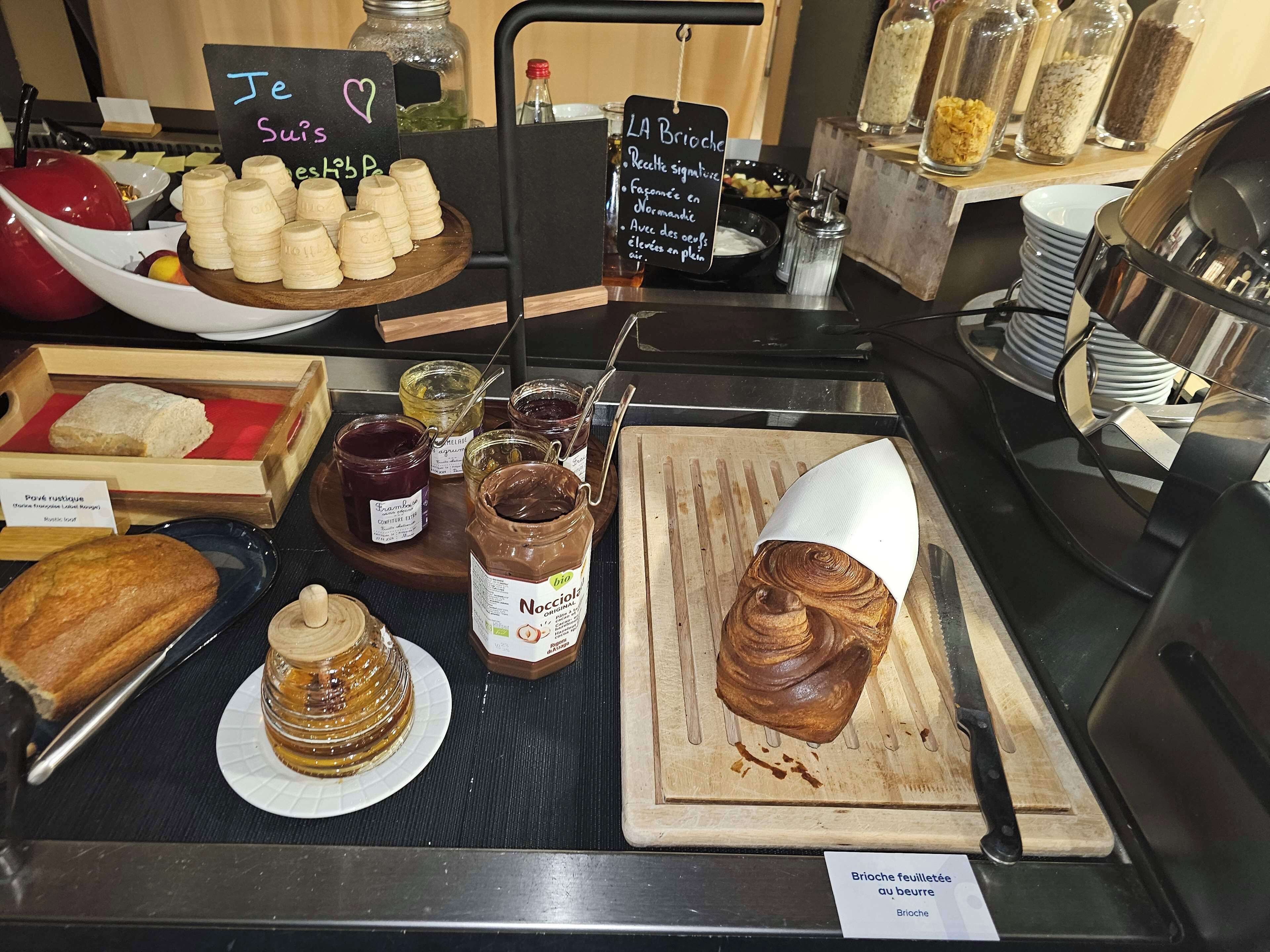 A bakery display with various baked goods and condiments.