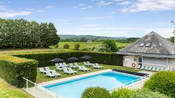 Seasonal outdoor pool, open 9:00 AM to 8:00 PM, pool umbrellas