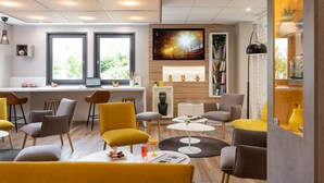 A modern interior with a bar area, seating, and a TV screen.