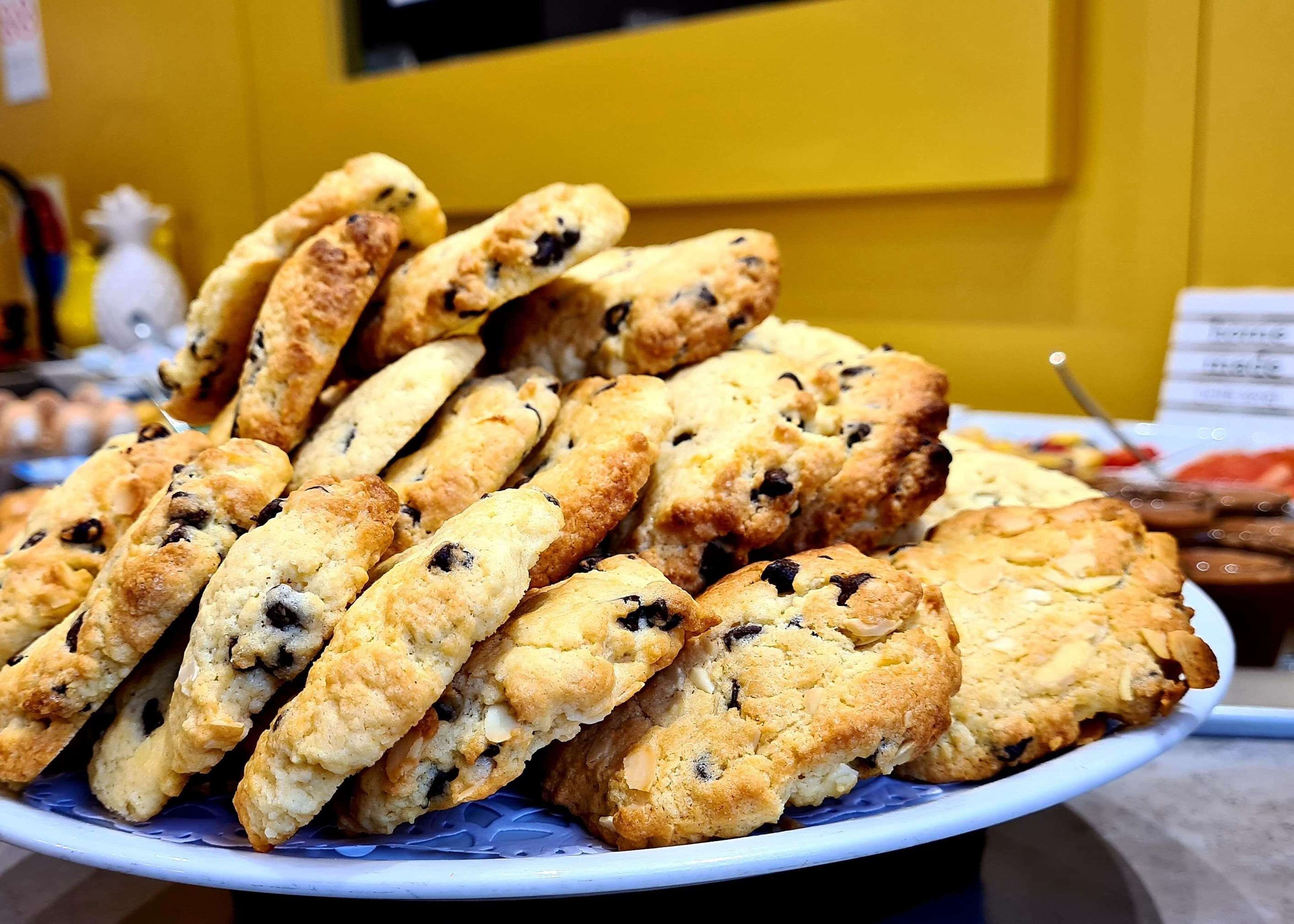 A plate of freshly baked scones with raisins and almonds.