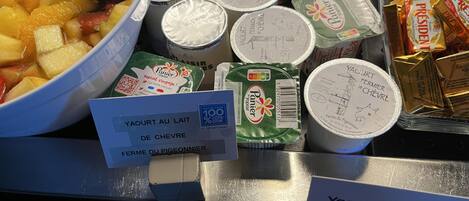 A display of dairy products including yogurt and cheese.
