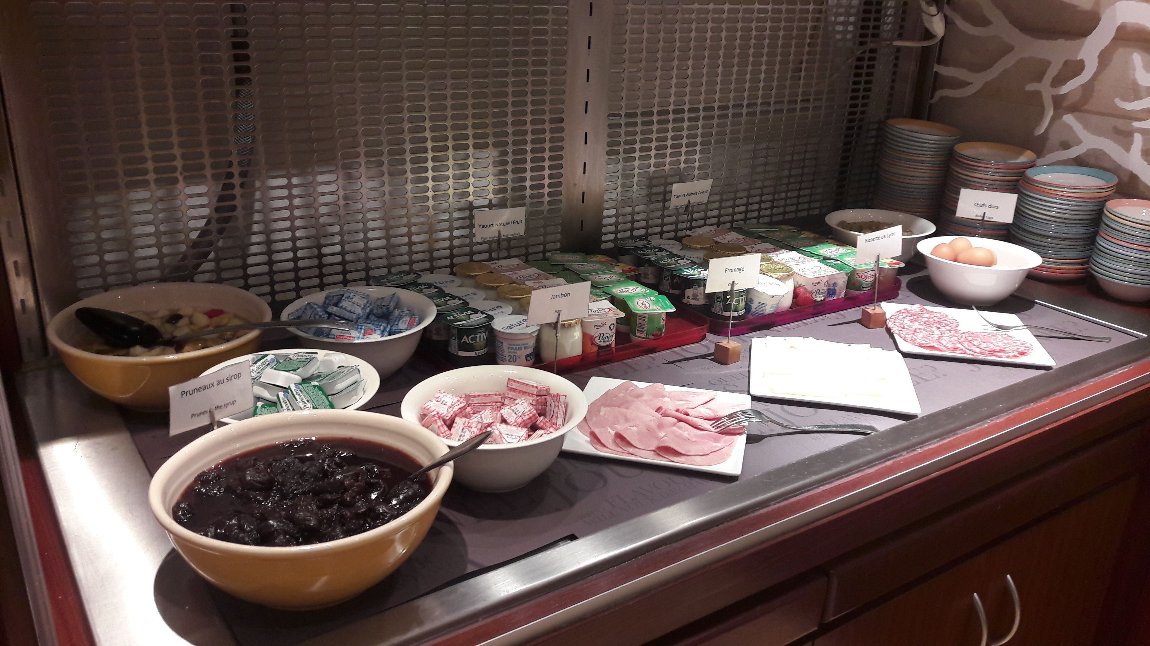 A buffet with various food items and condiments.