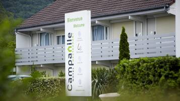 A hotel sign with "Bienvenue Welcome" and "Campanile Hotel Restaurant" text, indicating a welcoming entrance and a restaurant.