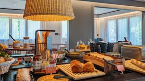 A breakfast buffet with various breads, pastries, and spreads. - Hotel Campanile Grenoble Nord - Saint Egrève (Saint-Egreve)