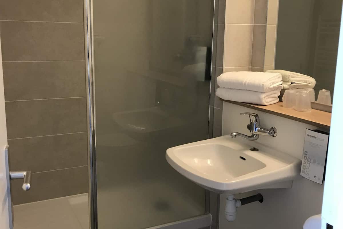 bathtub, eco-friendly toiletries, hair dryer, towels