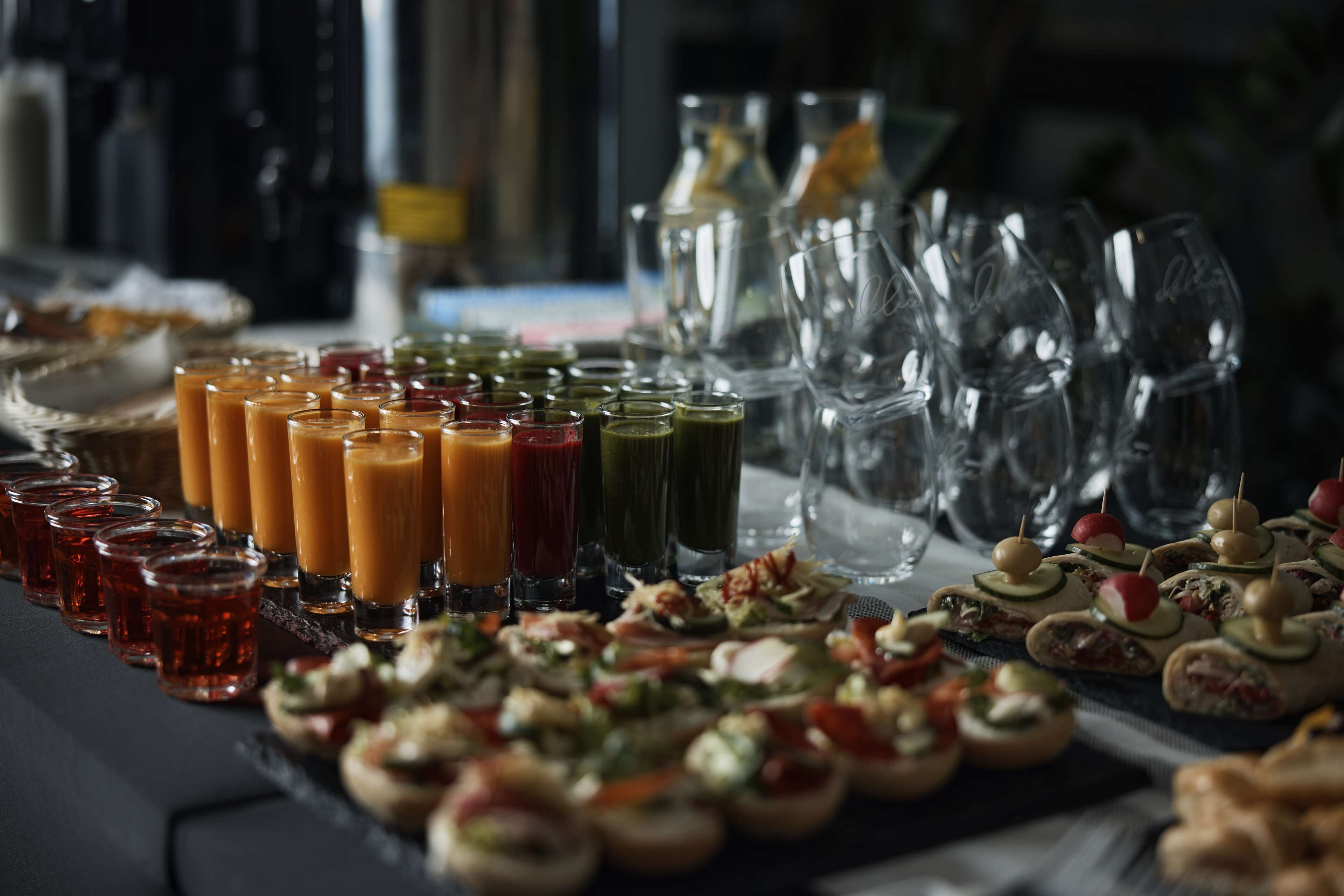 A buffet table with various food items and drinks.