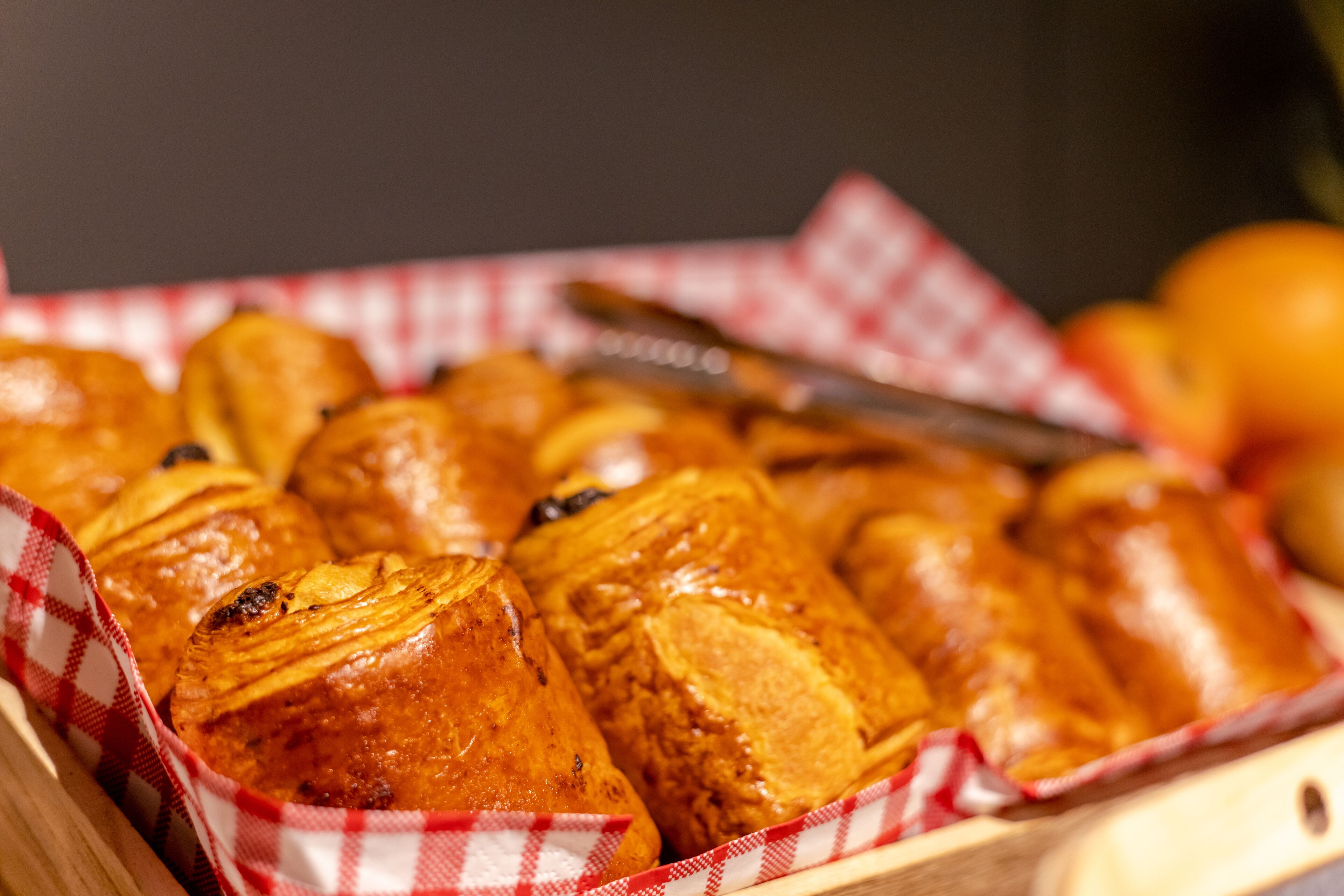 A tray of pastries in a checkered cloth.