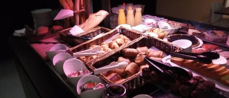 A buffet with various food items and beverages.