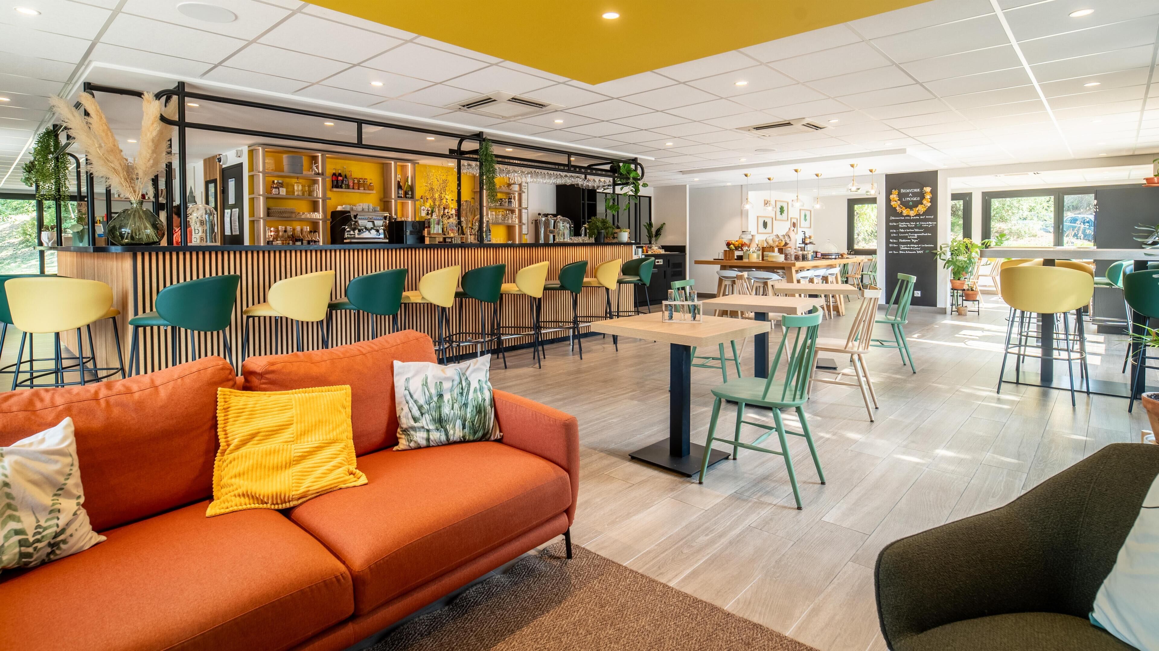 A modern cafe with a bar area, seating arrangements, and a variety of plants.