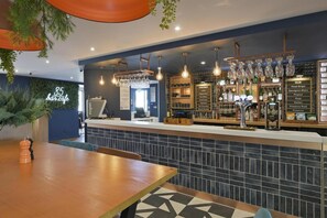 A bar area with a counter, seating, and a menu board. - Hotel Campanile Dartford (Dartford)