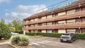 A multi-story hotel with a sign reading "Kyoto DIRECT".