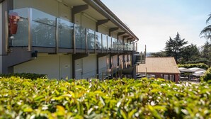A modern building with a glass balcony, a flat roof, and a clear sky. - Kyriad Lyon Sud Sainte Foy (Sainte-Foy-les-Lyon)