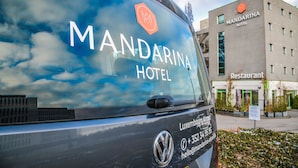 A vehicle with "MANDARINA HOTEL" and contact information for the Luxembourg Airport. - Mandarina Luxembourg Airport Hotel (Niederanven)