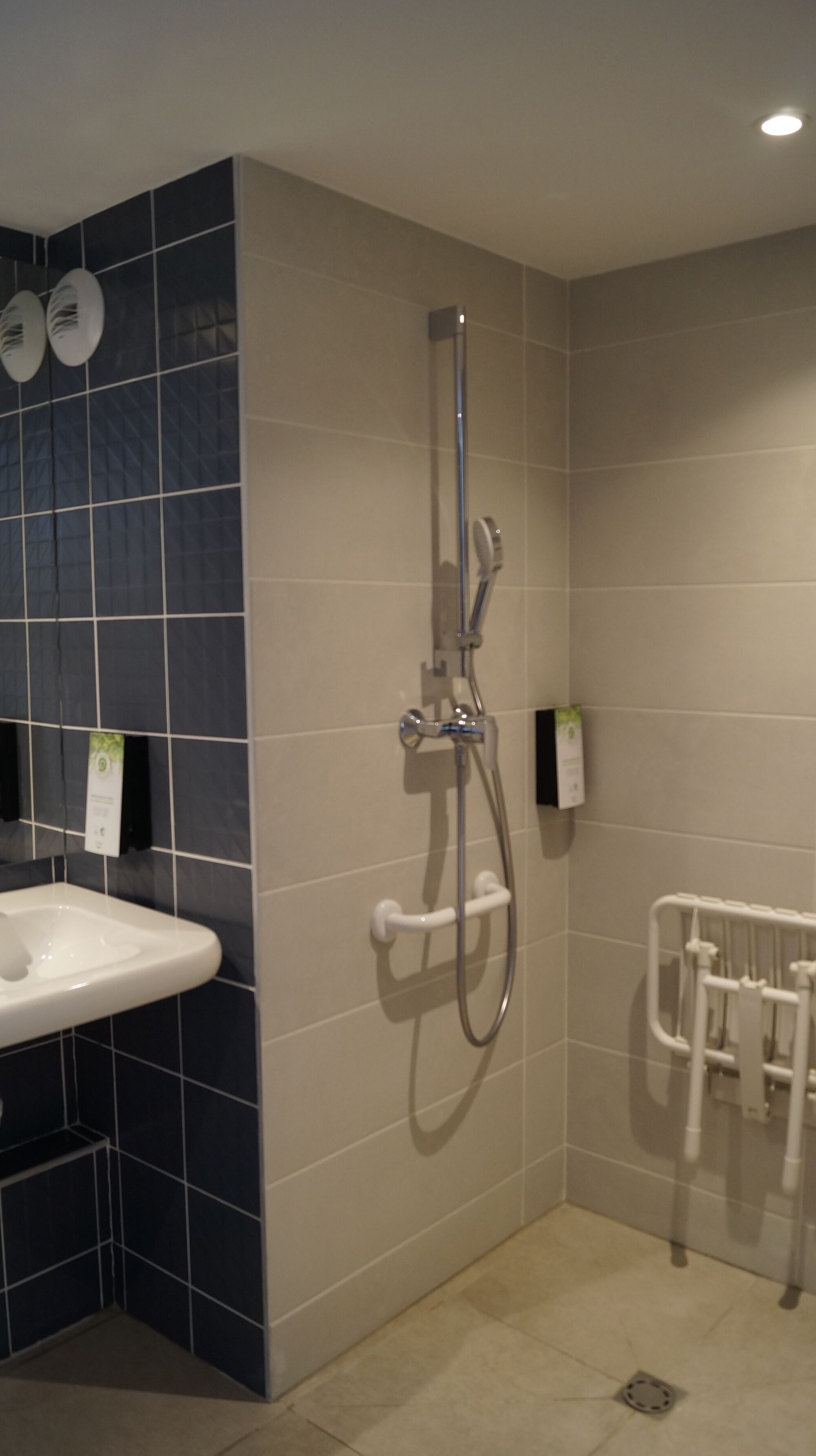 A bathroom with a shower, a sink, and a toilet.