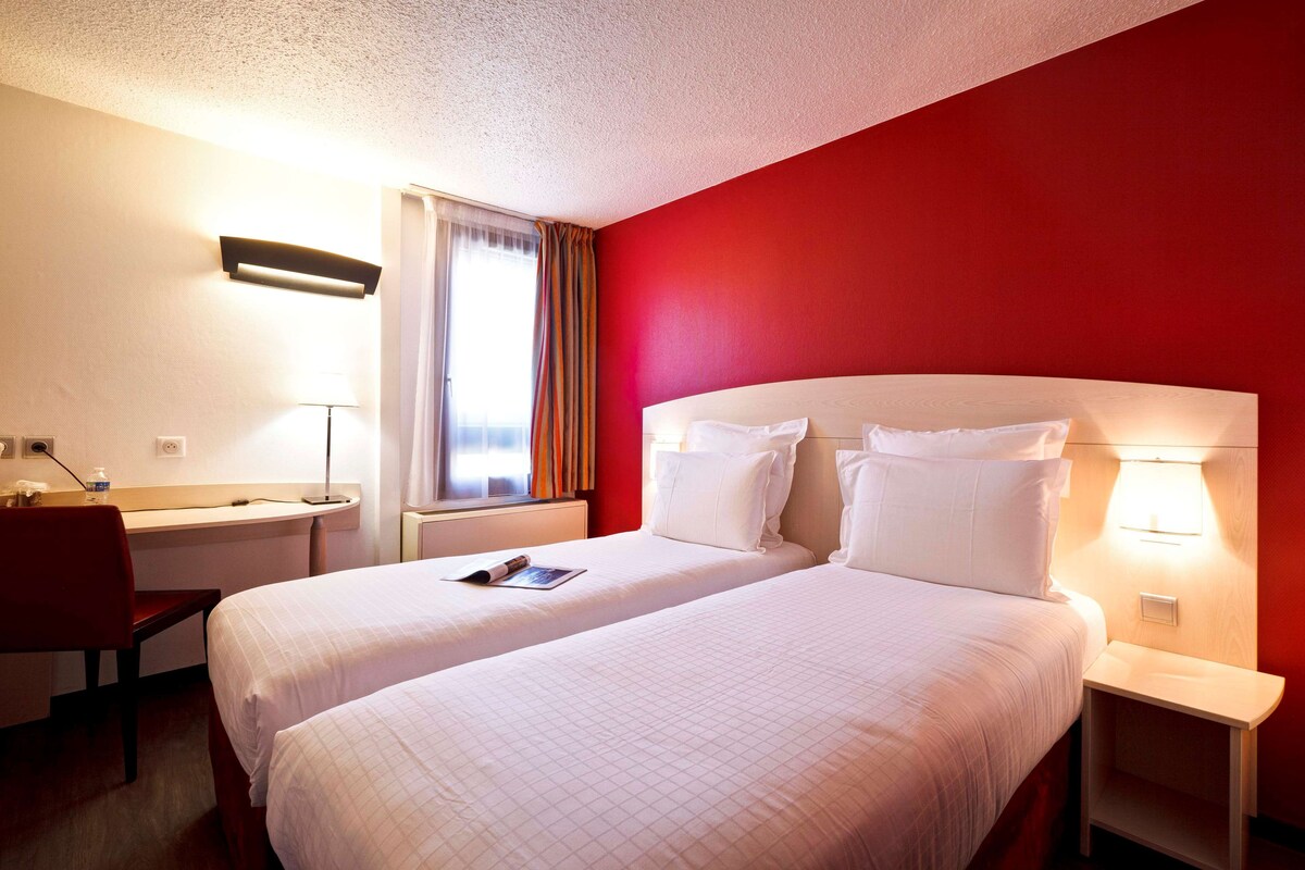 Premium bedding, desk, laptop workspace, blackout drapes
