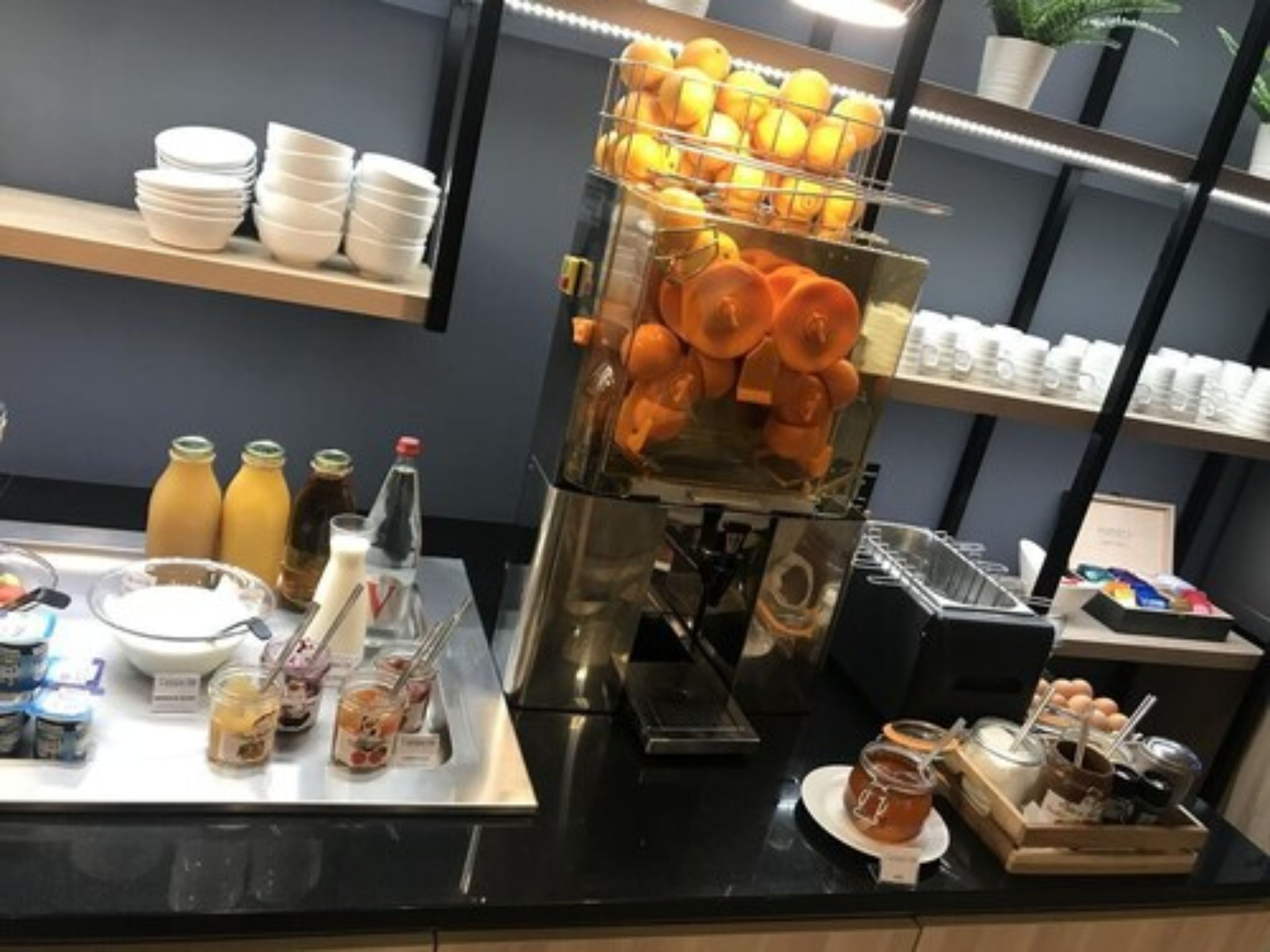 A breakfast buffet with various food items and beverages.