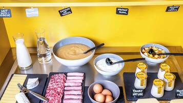 A breakfast buffet with various food items and condiments.
