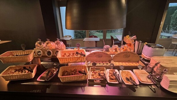 A buffet table with various food items and serving utensils. - Campanile Orleans Saran (Saran)