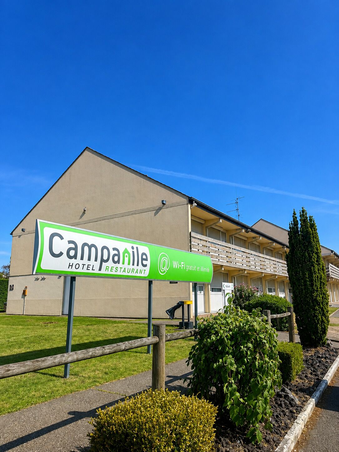 A hotel sign with 'Campanile HOTEL RESTAURANT' and Wi-Fi availability.