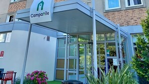 A multi-story hotel building with a prominent 'Campanile' sign, featuring a modern design with brick accents and multiple windows. - Campanile PRIME - Paris Bobigny (Bobigny)