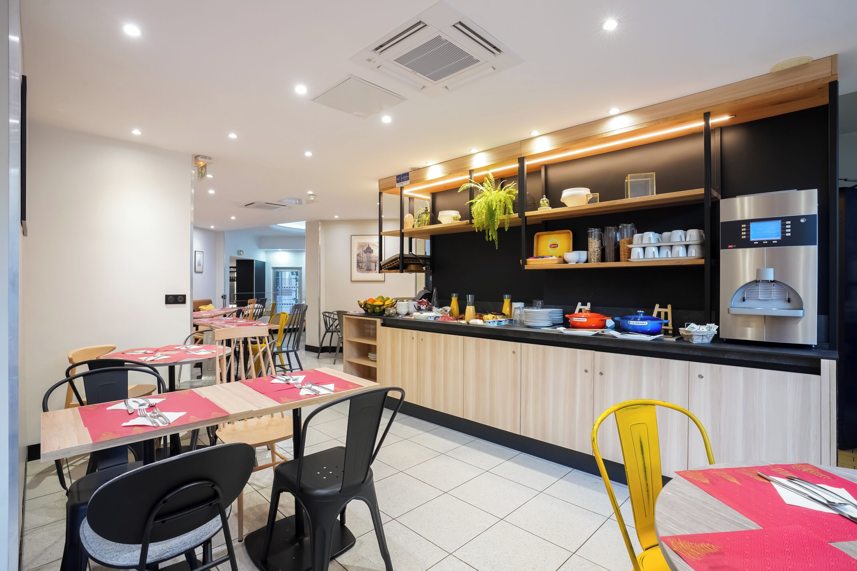 Una cocina moderna con una isla central, equipada con una cafetera y diversos electrodomésticos.