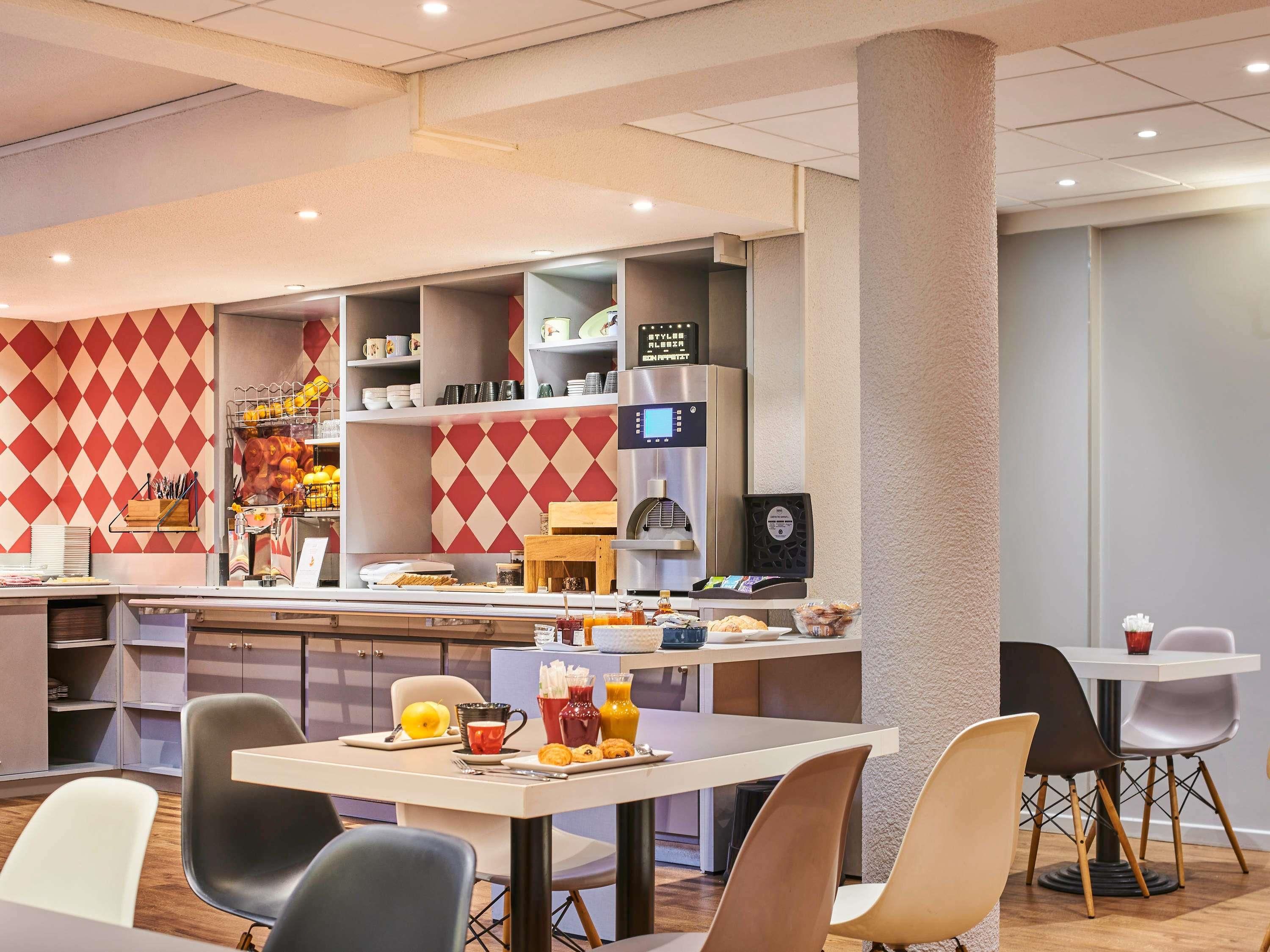 A modern breakfast area with a counter, seating, and a coffee machine.