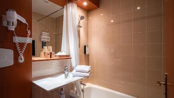 A modern bathroom with a sink, mirror, and shower.