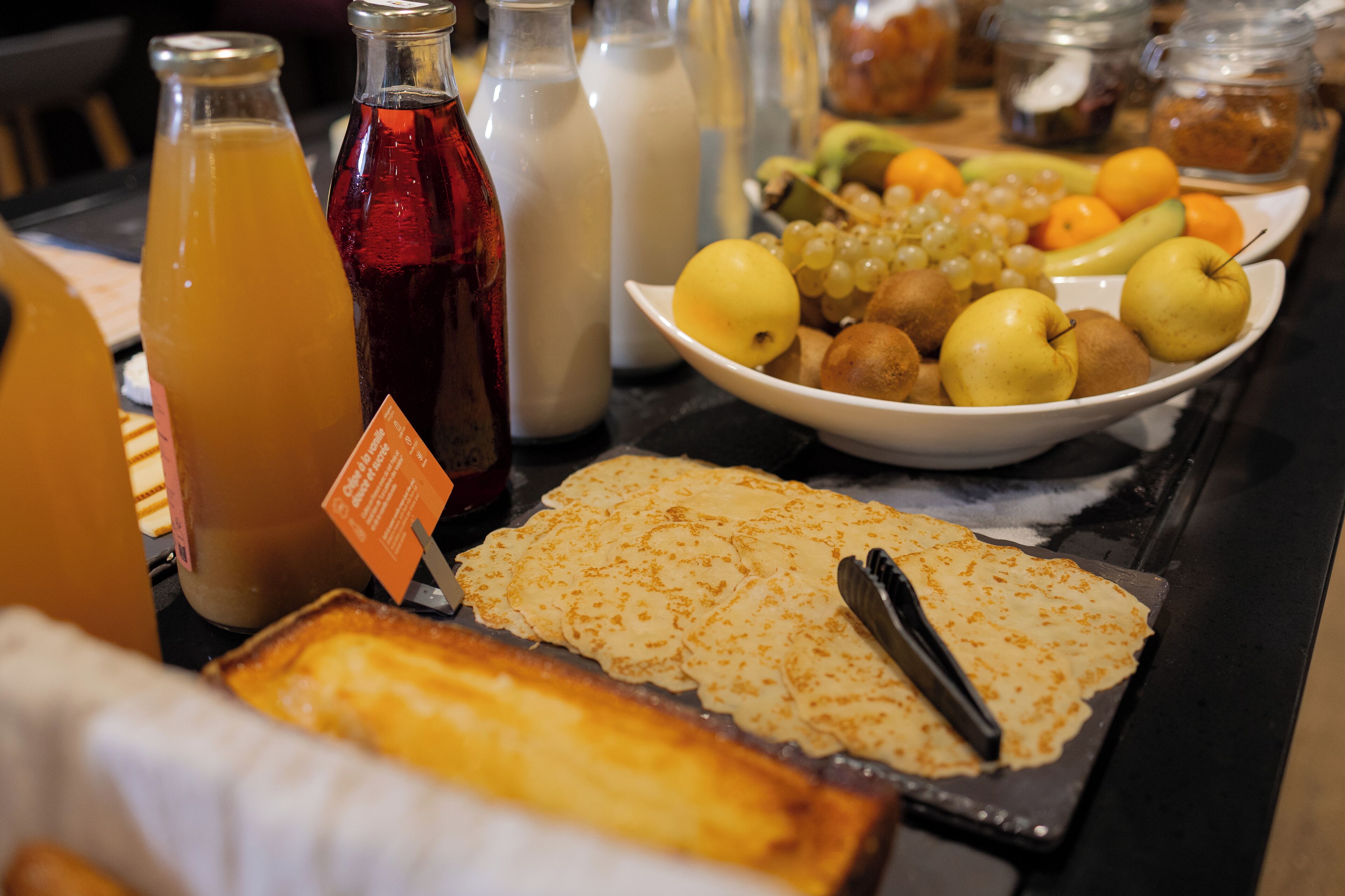 A breakfast buffet with various food items and beverages.