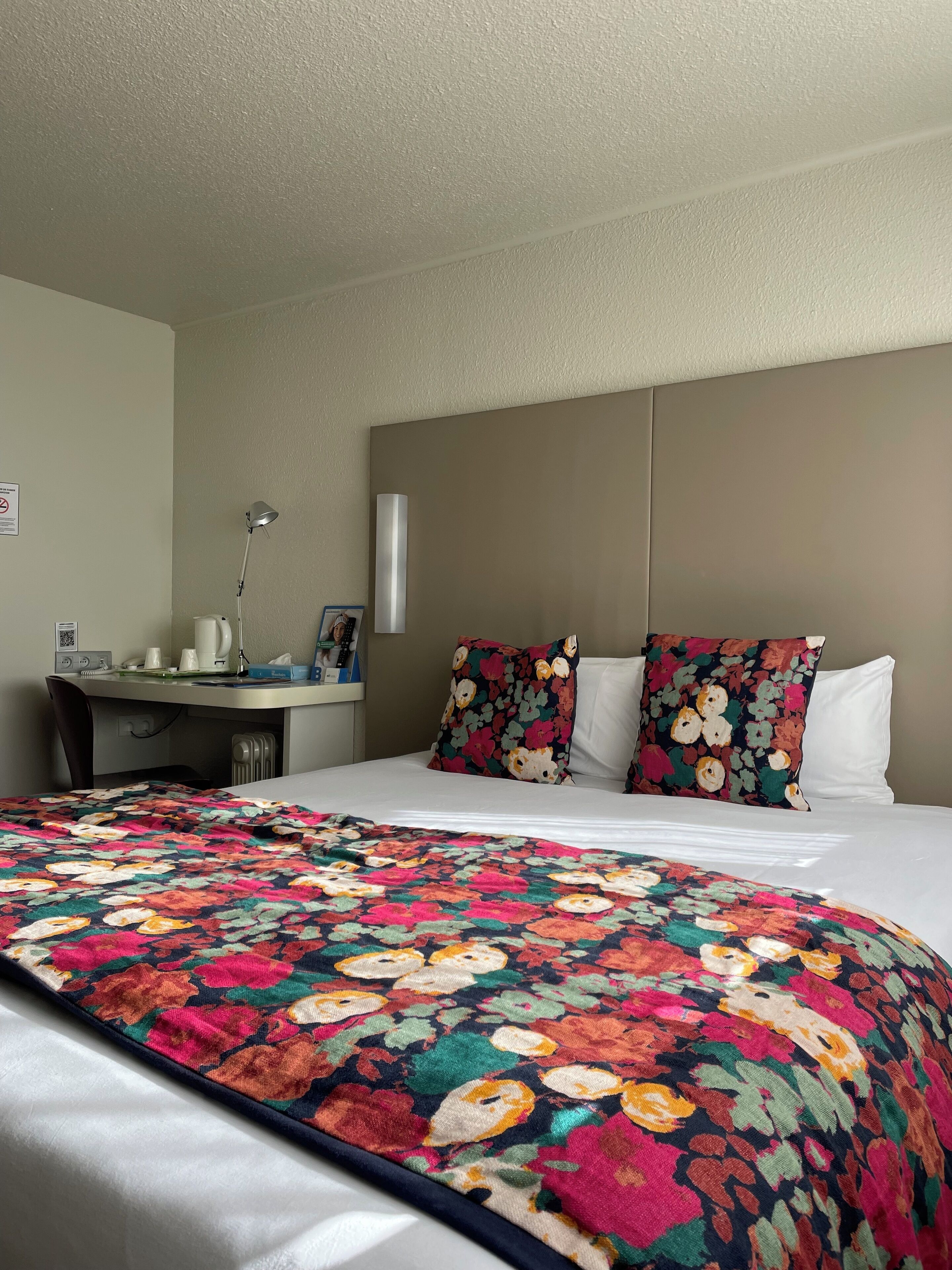 Premium bedding, desk, laptop workspace, blackout drapes