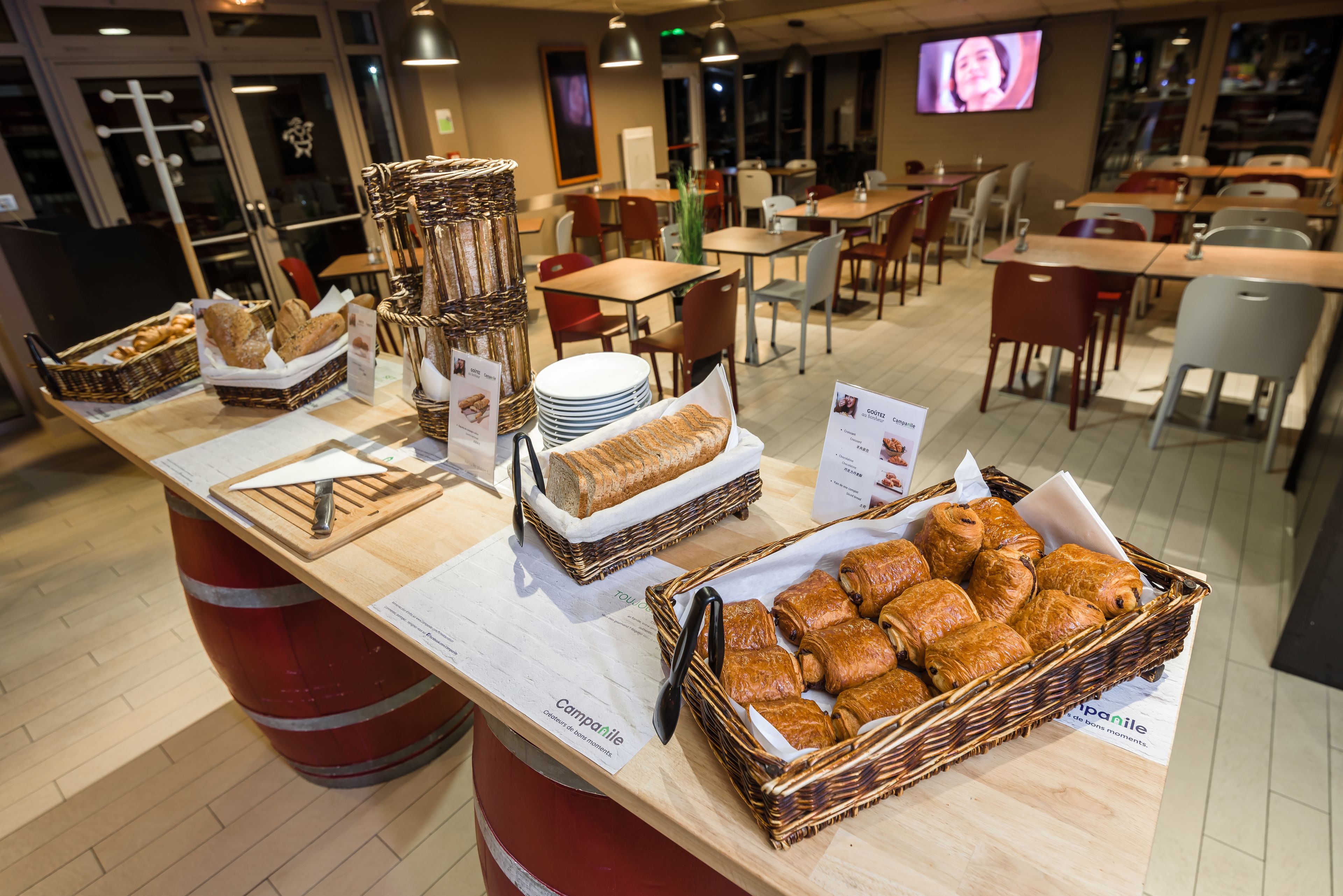 A buffet area with various bread and pastries displayed in baskets.