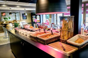 Een buffet met verschillende soorten eten en bestek.