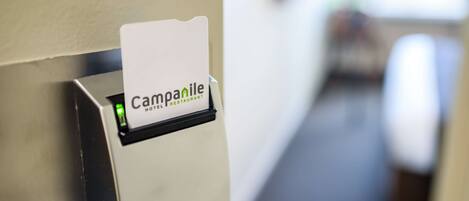 A hotel sign with the name "Campanile Hotel Restaurant" mounted on a wall.