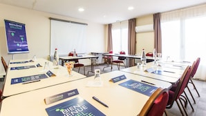 A conference room with tables, name cards, and a welcome banner.