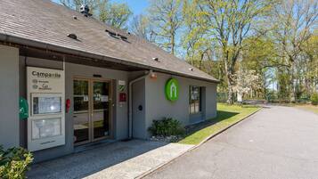 A hotel entrance with a sign for 'Campanile Hotel Restaurant' and a green logo.