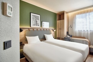 A hotel room with two beds, a desk, a chair, a lamp, and a window with curtains. - Campanile PRIME - Wroclaw Stare Miastro (Wroclaw)