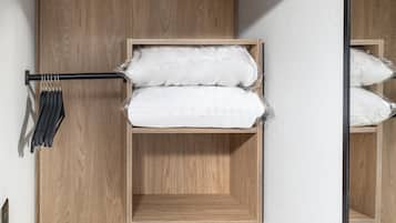 A compact, multi-level wooden storage unit with a built-in heater, a hanging rack, and a shelf.