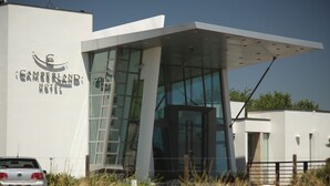 Ein modernes Hotel mit Glasfassade und weißer Außenwand.