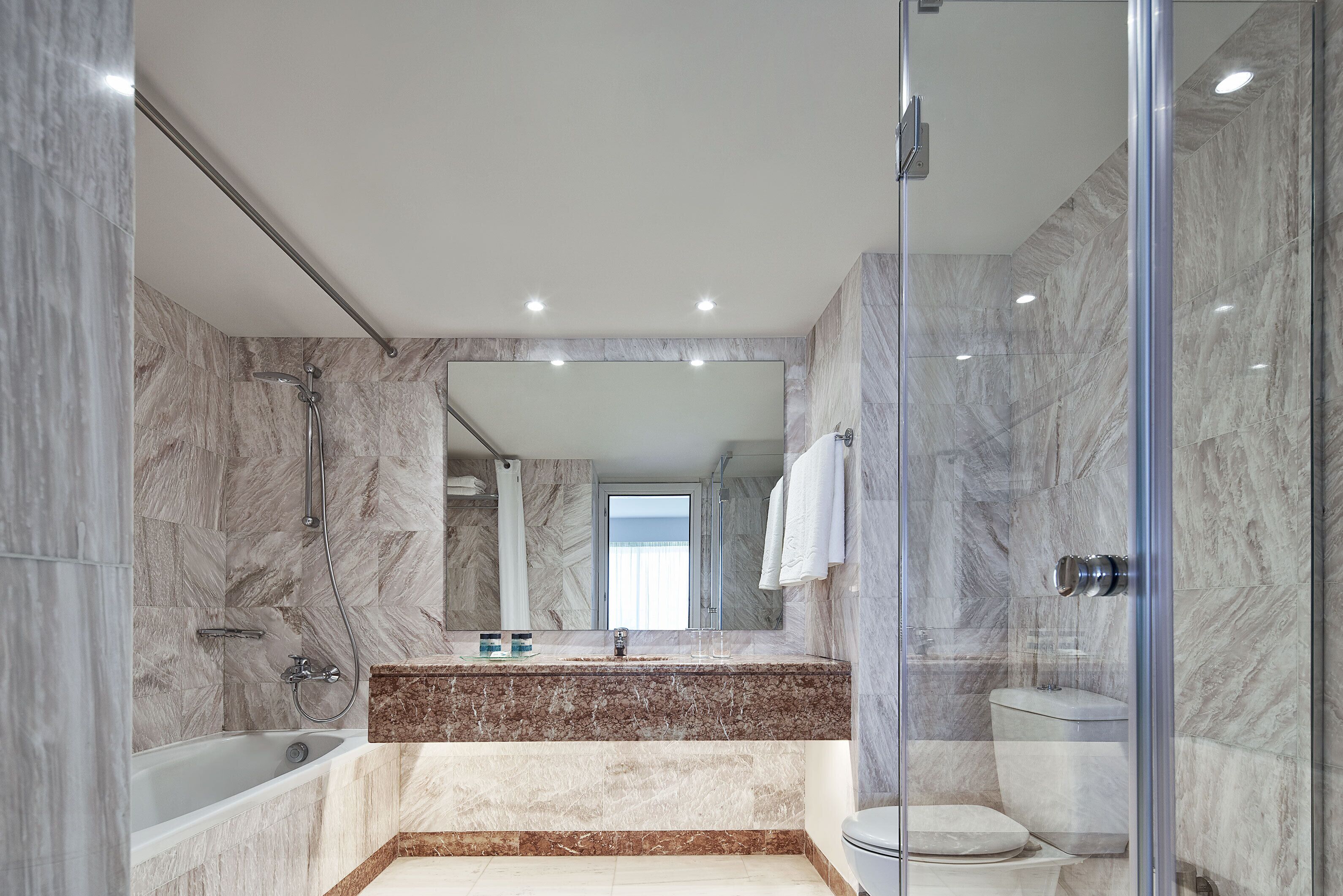 bathtub, hair dryer, slippers, towels