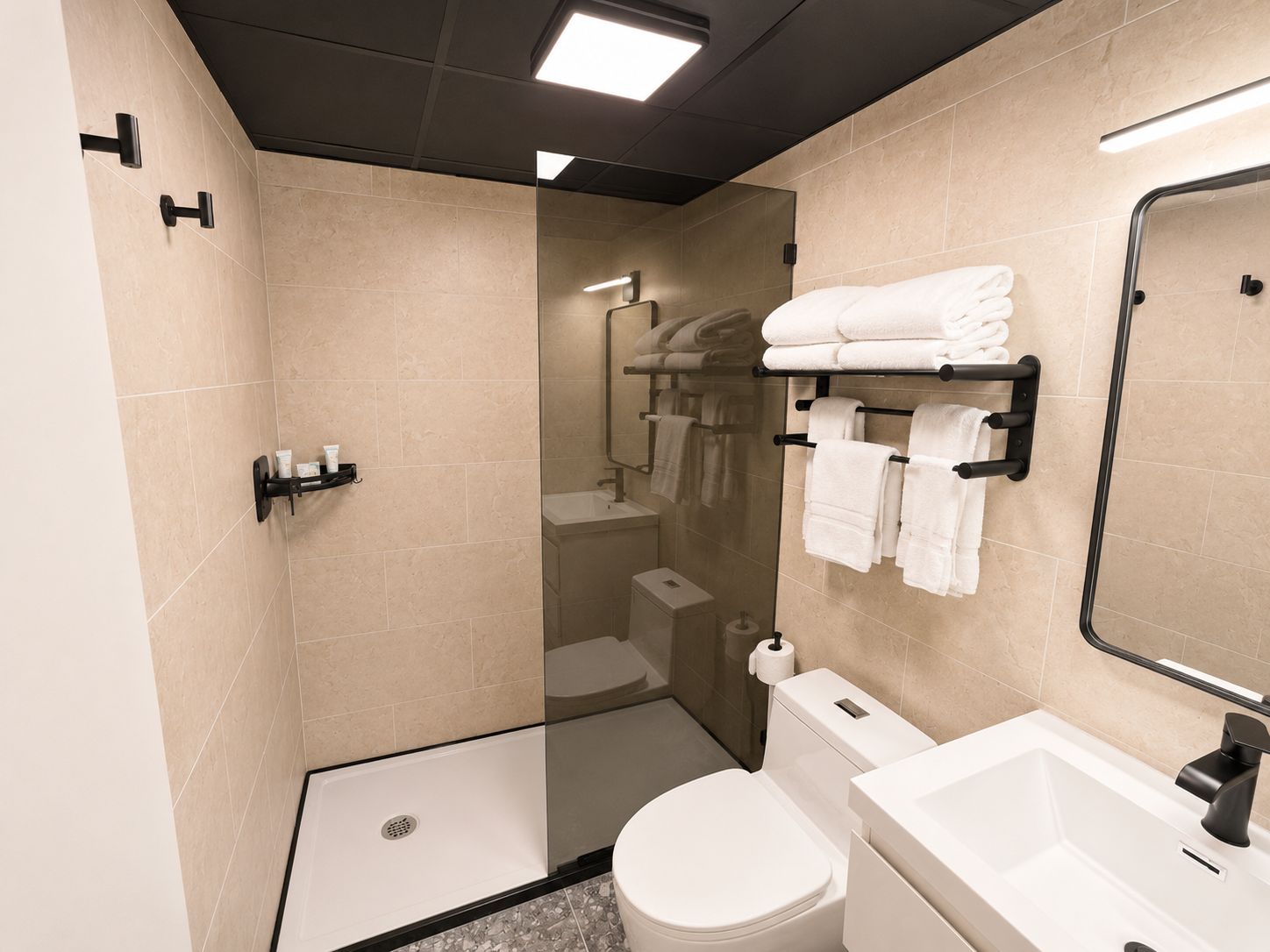 A modern bathroom with a glass shower enclosure, a toilet, a sink, and a towel rack with neatly folded towels.