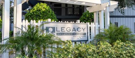 Una estructura de pérgola blanca con un letrero de Legacy Vacation Resorts.