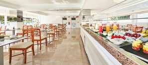 A spacious dining area with multiple tables and chairs, a buffet counter with various food items, and a clear view of the outside through large windows. - Globales Torrenova Adults Only +16 (Calvia)