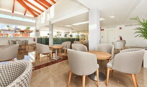 A modern hotel lobby with a bar area, seating arrangements, and a view of the outside. - Globales Torrenova Adults Only +16 (Calvia)