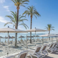 On the beach, white sand, beach towels, beach volleyball